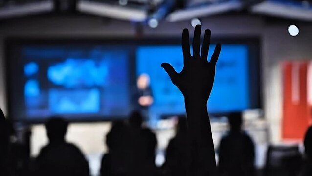 The concept of active participation exemplified as a hand is raised for a question during a compelling presentation, fostering engagement and interaction
