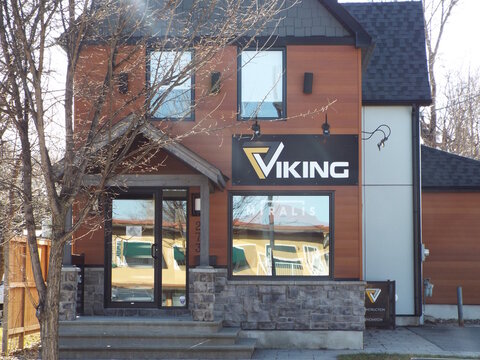 Gatineau, Quebec, Canada &ndash; April 19, 2026: The "Viking Construction" office features modern wood and stone siding with bold black signage on a bright day at #2, 273 Bd Saint-Joseph.