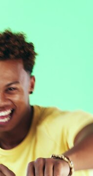 Happy man, face and excited with dancing in studio, celebration and movement on green background. Person, smile and dancer with rhythm, achievement and confident with success with goal in Costa Rica