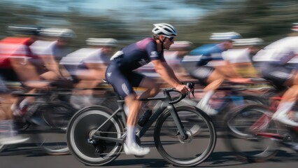 Fototapeta premium Cyclists in motion blur race, capturing speed and intensity on a sunny day.