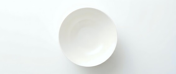 Fototapeta premium Empty white ceramic bowl shot from above on a white background, isolated and ready for design use in food, kitchen, and lifestyle projects.