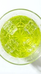Obraz premium Bright green cocktail with ice cubes in a crystal glass, top view on white background. Refreshing summer drink concept for menu and bar design.