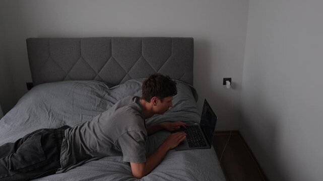 Remote worker changing positions around apartment while working on laptop, authentic freelance routine and modern digital lifestyle in small living space