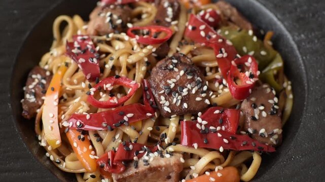Food, Chinese or Japanese noodles with meat, vegetables, and spices. Noodles with beef or chicken as a food background for your design