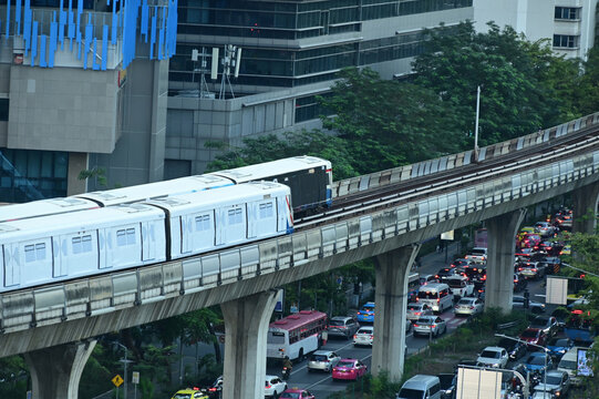 Top view of a BTS Skytrain on elevated rails in Silom district. A Silom Line BTS Skytrain traveling along its  elevated track bed high above busy Ratchadamri Road.