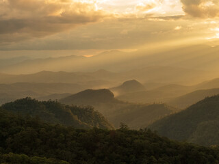 Obraz premium Blue golden sky sunrise dramatic beautiful landscape mountain. Dramatic sunset over mountain landscape. Beautiful landscape foggy hills twilight time. Dawn sky gold dusk time cloudscape with sunlight
