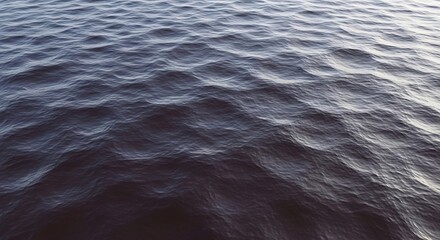 Fototapeta premium Close-up of Dark Blue Water Surface with Gentle Ripples and Sunlight Reflections.