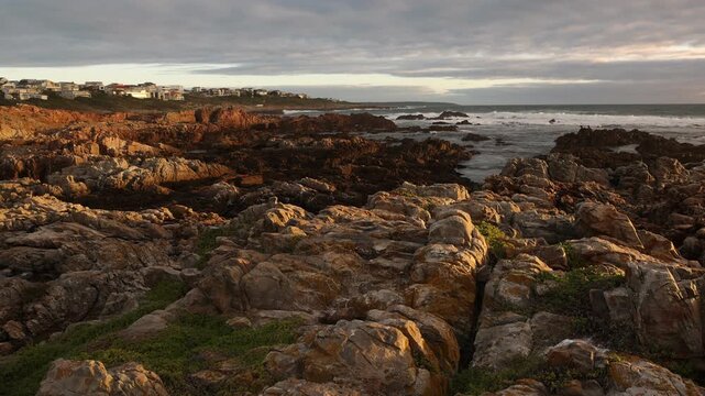 sunset light over rocky coastline of DeKelders, Gansbaai, South Africa