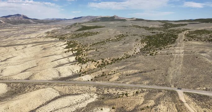 Aerial of northeast Utah desert with Highway 191 in low rolling dry hills in spring