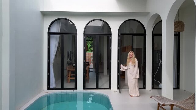 Luxury Bali Style White Villa With Pool And Blonde Woman Opening Door, Drone Shot