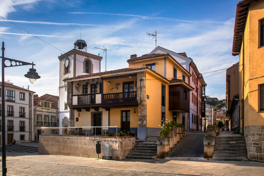 Charming town square with traditional architecture and clock tower in Luanco, Asturias, Spain