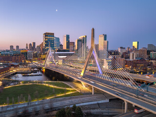 Fototapeta premium Zakim Bridge and Boston skyline glowing at sunrise