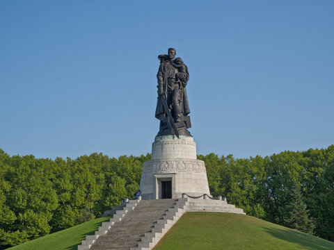 Sculpture of a soldier with a sword carrying a child, Soviet war memorial in Treptower park, Berlin, Germany 