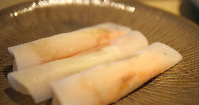 Cinematic close-up of delicious roasted duck spring rolls served on a premium dark ceramic plate, gourmet Asian fusion appetizer concept