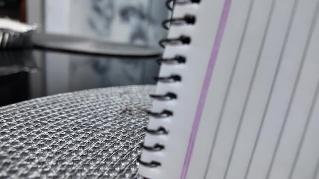 Wooden letters spell DATA next to a lined notebook