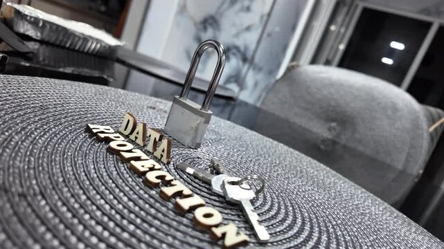 Padlock and wooden letters spelling DATA PROTECTION on textured surface