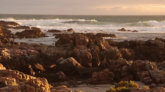 sunset light over rocky coastline of DeKelders, Gansbaai, South Africa