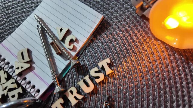 Wooden letters spelling ZERO TRUST scattered with office supplies