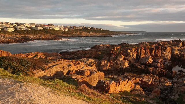 sunset light over rocky coastline of DeKelders, Gansbaai, South Africa