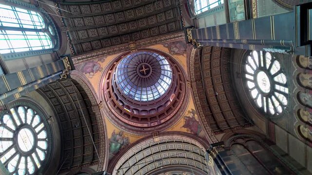 Amsterdam, Netherlands February 20 2026 A breathtaking bottom-up view of the ornate dome inside the Basilica of Saint Nicholas highlighting symmetrical art and celestial light.