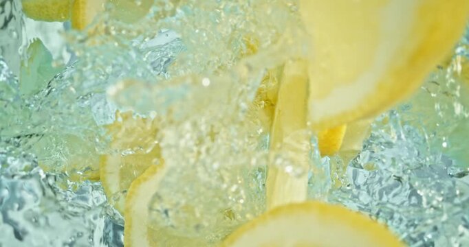 Super slow motion 1000fps video of fresh lemon slices falling into rippling water, creating a sparkling splash, perfect for drink, cocktail and summer visuals.