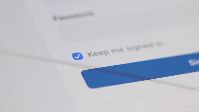 Macro 4K shot of a finger checking and then unchecking the "Keep me signed in" box, toggling login session preferences.