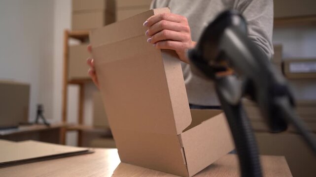 Assembling cardboard box in post office working in global trade logistics and delivery hub.