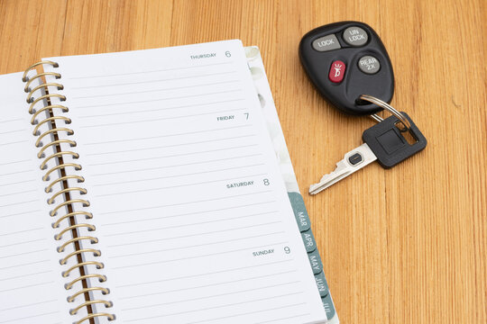 Car keys and planner for auto finance on wood desk