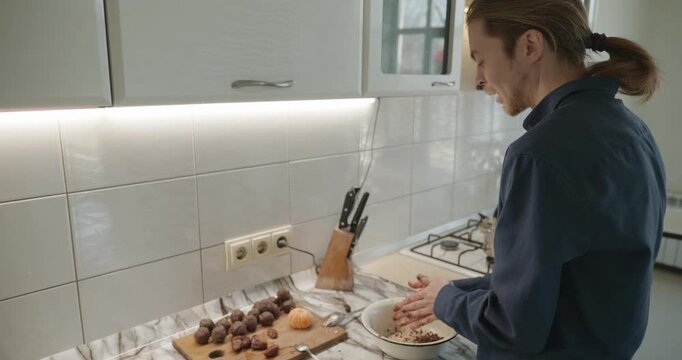 Caucasian man prepares desert at kitchen at home. 4K 10-bit