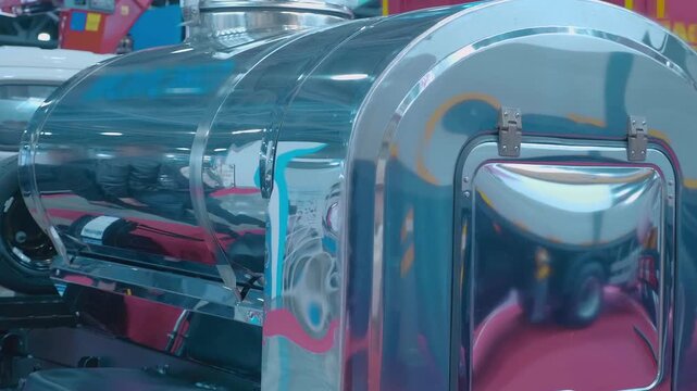 A chrome-plated mirror tanker truck, designed for any cargo, such as fuel, chemical solutions or for the food industry, is presented at the exhibition. Shot in motion  