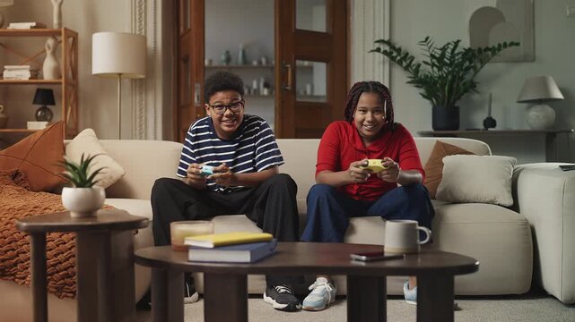 Black siblings celebrating video game win with their signature handshake