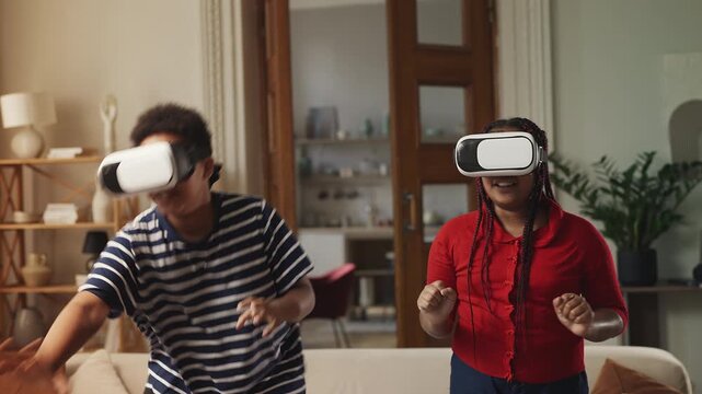 Smiling Black siblings wearing VR headsets while playing interactive video game