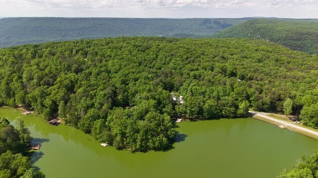 Aerial View of Forested Mountain Ridge Above Lakeside Community in Menlo Georgia