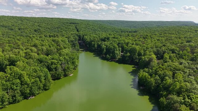 Low Altitude Aerial Drone Shot Over Forested Lake in Mountain Community Menlo Georgia
