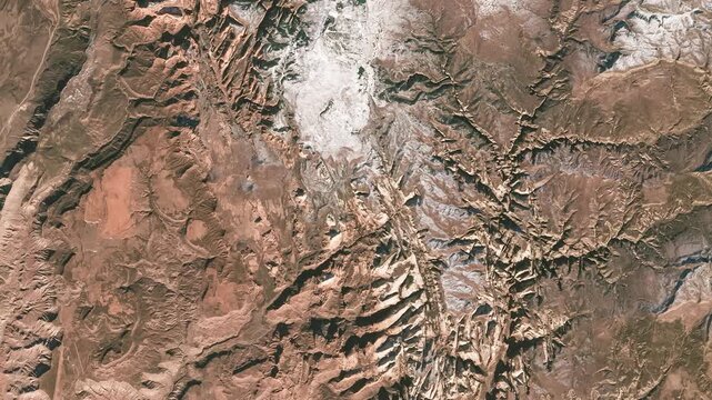 Aerial shot of dry land with gully forms of erosion. Camera is moving right and up. Animation based on image by NASA
