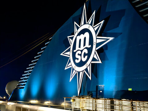 Fuerteventura, Spain, April 7, 2026 - Large MSC logo on cruise ship funnel at night with lighting and dark sky in harbor.