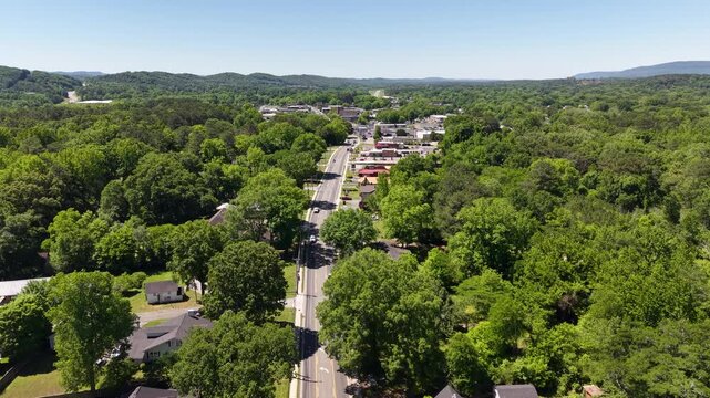 Aerial Drone View Looking Down Main Street Corridor with Storefronts and Mountains LaFayette Georgia