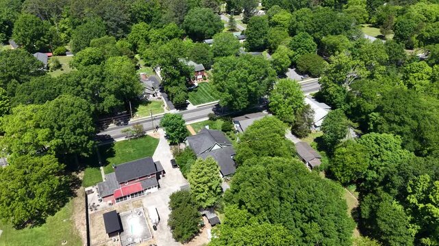 Angled Aerial Drone View of Residential Streets and Homes Surrounded by Trees in LaFayette Georgia