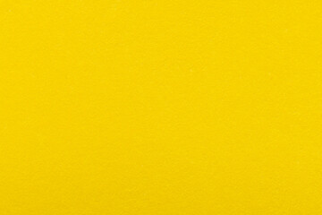 Fototapeta premium Vibrant Yellow Textured Paper Background,A close-up, high-angle shot of a vibrant yellow textured paper surface, showing fine grain details. Ideal for use as a background, backdrop, or abstract.