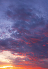 Fototapeta premium Dramatic vibrant sunset sky with purple and orange clouds,Beautiful dramatic sunset sky filled with vivid purple, blue, and fiery orange clouds, perfect for nature backgrounds, concepts of hope,