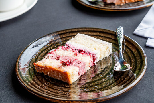 A slice of delicious creamy torte layered with fruit mousse on a plate