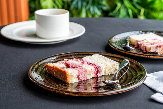 A slice of delicious creamy torte layered with fruit mousse on a plate