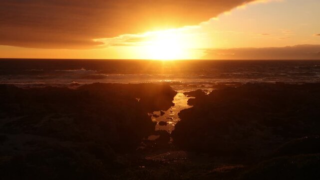 sunset light over rocky coastline of DeKelders, Gansbaai, South Africa