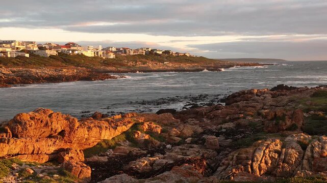 sunset light over rocky coastline of DeKelders, Gansbaai, South Africa
