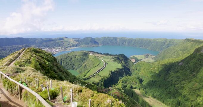 A beautiful view of a volcanic lake in a crater surrounded by mountains at Sete Cidades.
