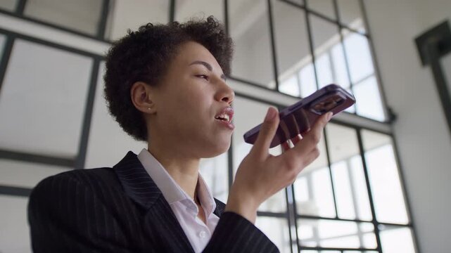 Businesswoman using voice command on smartphone