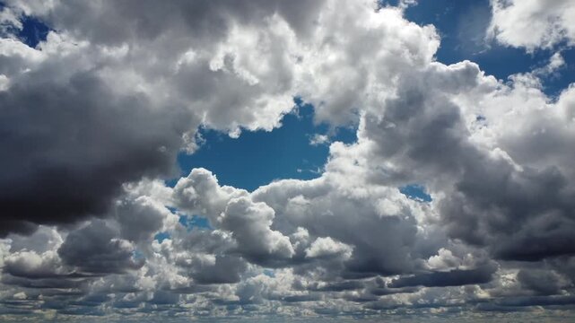 4K aerial drone flight through dramatic storm clouds, cinematic dark and white cumulus cloudscape, majestic atmospheric weather, moody sky background with deep contrast, high altitude aerial perspecti