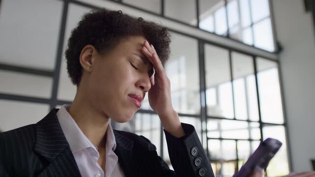 Businesswoman stressed after layoff message