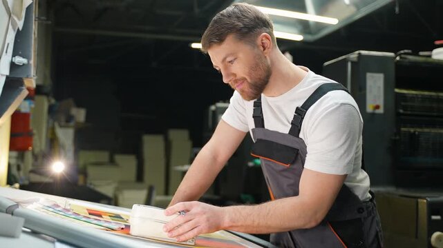Male graphic designer working at print plant factory