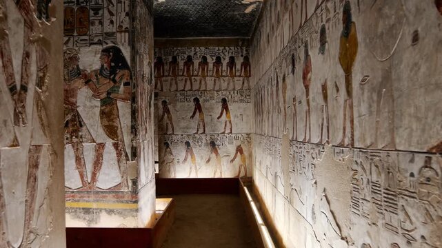 Close-up of ancient Egyptian relief carving inside KV17 tomb of Seti I, Valley of the Kings, Luxor, Egypt, showing a deity figure with black hair and deteriorating pigment.